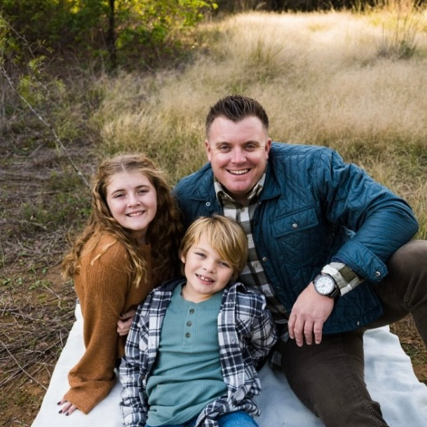 Cody, 3rd Day Roofing owner, with his two children outdoors